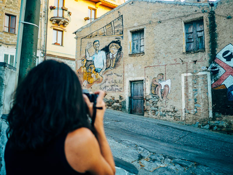 Colorful political murals covering building walls in Orgosolo village